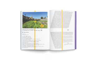 An overhead shot of an open book with German text on pages 326 and 327. The left page features a large color photo of a cityscape with a mosque and sunflowers by a river, above the heading, We can all be like sunflowers, Ein Kunstwerk für die Umwelt von Agnes Denes. The right page consists of columns of text.