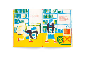A colorful, stylized two-page illustration from a German book. On a bright yellow floor, a person with blue hair in a bun is shown lifting a large, patterned block on the left page. On the right page, they stand holding the block. The background features blue and green bookshelves. The art style has a textured, block-print quality.