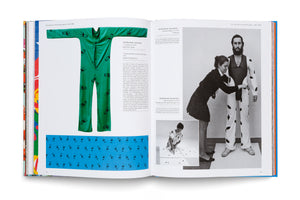 An open book showing a two-page spread with German text and photographs from a chapter on the 1970-1980 protest movement. The left page displays a bright green jumpsuit with a black chair pattern. The right page has black-and-white photos of a woman fitting a spotted outfit on a man and another woman ironing.