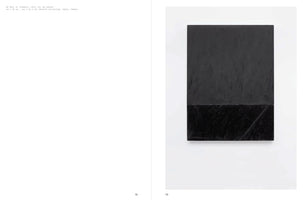An open art book showing pages 78 and 79. The page on the right features a vertical abstract painting, WT Roll 2C (Chance), 1974. The oil on canvas is a black rectangle divided into a large matte upper section and a smaller, glossier, textured lower section. The left page contains the artwork's caption against a white background.
