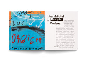 A two-page spread from an art book about Jean-Michel Basquiat. The left page displays a close-up of his vibrant painting with a turquoise background, featuring abstract black and white shapes, red spray-painted numbers, and the black text THE GUILT OF GOLD TEETH. The right page is titled Jean-Michel Basquiat in Modena and contains an article in German.