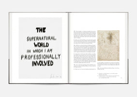 A photograph of a two-page spread in an open book. The left page features a text artwork in a bold, handwritten black font that reads, THE SUPERNATURAL WORLD IN WHICH I AM PROFESSIONALLY INVOLVED. The right page contains an interview transcript next to a small anatomical drawing by Leonardo da Vinci.