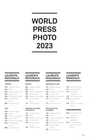 A table of contents page from the World Press Photo 2023 publication, written in French. The page features the title at the top, followed by four columns. Three columns detail the Regional Winners (Lauréats Régionaux) organized by continent: Africa, Europe, South America, Asia, North & Central America, and Southeast Asia & Oceania. The fourth column lists the Global Winners (Lauréats Mondiaux), including Photo of the Year. Each entry is paired with its corresponding page number.
