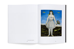 An open art book viewed from above against a white background. The right page features a naive-style painting of a woman with dark hair in a short white dress and striped stockings, holding a bouquet of white flowers. She stands in a dark field under a bright blue sky with three yellow birds in flight. The left page is mostly blank with the title Die Schauspielerin Margarita.