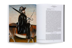 An open art book on a white surface. The left page shows a full-page reproduction of a painting by Niko Pirosmanashvili depicting a man with a beard in a dark coat and hat, riding a donkey. The right page features an essay in German about the artwork.