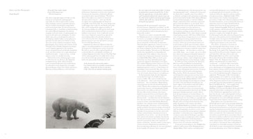 A two-page spread from a book. The left page features a large, black-and-white photograph of a polar bear standing over a seal on a snowy landscape, with text above it. The right page contains three columns of dense, black text.