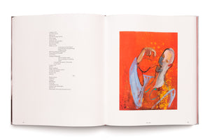 An overhead shot of an open book on a white surface. The left page contains a poem, while the right page displays an abstract painting of two figures against a vibrant orange and red background, with the caption Tea_time below it.