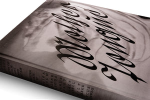 An angled, close-up photograph of a hardcover book by Camille Henrot against a white background. The book has a textured, monochrome cover featuring the title, Molybdophony, in a large, black, calligraphic script over a blurry, smoky image. The spine with text is visible to the left.