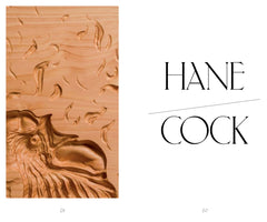 A two-page spread from a publication. On the left page, there is a detailed wood carving of a rooster's head against a light-grained wood background with smaller, comma-like shapes carved above it. The right page features the word HANCOCK in a stylized, black serif font on a plain white background, with a diagonal line separating HANE on the top line from COCK on the bottom line.