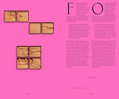 A two-page book spread on a vibrant pink background. The pages contain columns of text in two different languages and feature several small, framed wooden relief carvings. The carvings show detailed, deconstructed parts of a police robot, including its tracks, a mechanical claw, and a mounted weapon.