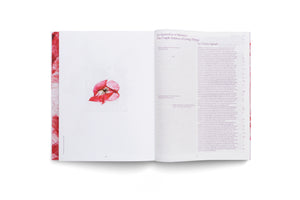 An open book laid flat against a white background. The left page shows a small, centered image of a pressed, translucent red flower. The right page is filled with black text, with the title An Apparition of Memory: The Fragile Balance of Living Things by Chiara Agradi at the top.