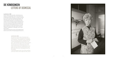 A two-page spread from a photo book. On the left, text in German and English is titled DIE KÜNDIGUNGEN / LETTERS OF DISMISSAL. On the right is a black-and-white photograph of a middle-aged woman with short, curly hair, wearing a floral work apron. She stands in a stark room, holding a white letter in her hands and looking directly at the camera with a somber expression, having just received her notice of dismissal.