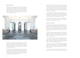 A page from a book featuring a large photograph of an art installation in a spacious hall with white arched walls and a dark stone floor. The white walls are covered in a dense, grid-like pattern of black dots, which are actually stand-up pens. The hall is symmetrical, with staircases on either side and modern pendant lights hanging from the ceiling. Columns of text surround the image.
