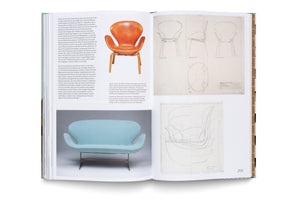 An open book about furniture design, showing German text on the left page. The right page, numbered 255, displays a photo of an orange leather Swan chair, a light blue sofa, and several technical design sketches of the chair from different angles.