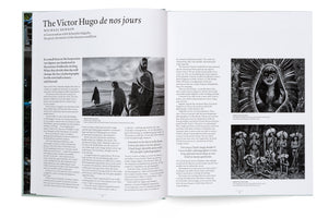 An open book displays a two-page article titled The Victor Hugo de nos jours, featuring a conversation with photographer Sebastião Salgado. The spread is laid out with text and several of Salgado's black-and-white photographs of people in Ethiopia and indigenous people in Brazil.