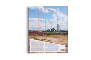 The back cover of a book displayed against a white background. The cover features a photograph of an industrial landscape with a quarry in the foreground and factory silos in the distance under a blue, cloudy sky. Thin red and grey lines form a geometric, architectural-style drawing over the image. The lower portion contains two columns of text in German and English, alongside a website address and a barcode.
