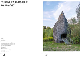 A two-page spread from a book. The left page, numbered 112, has German text detailing the artwork ZUR KLEINEN WEILE by raumlabor. The right page, numbered 113, shows a photograph of the artwork: a large, gray, conical sculpture resembling a hollow rock, set in a grassy landscape with trees. It features a dark, round entrance with a metal ramp leading up to it, and a small yellow window near its pointed peak.