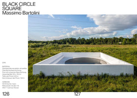 A page from a publication showing Massimo Bartolini's outdoor installation, Black Circle Square. The minimalist artwork features a white, square concrete basin containing a large, black circular pool. The structure is situated in a wide, green field with trees in the background under a blue sky with clouds. Text in German is on the left-hand side of the image.