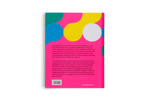 The back cover of a book with a bright pink background. At the top, there is a graphic of large, overlapping circles in teal, blue, yellow, and white. Below the graphic, two paragraphs of black text describe the book's content about global bike culture. An ISBN barcode and a website address are at the bottom.