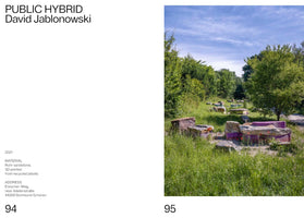 A two-page spread from a book about the artwork PUBLIC HYBRID by David Jablonowski. The left page contains text details about the piece. The right page shows a photograph of the outdoor installation, which consists of several low, blocky sculptures made of rough sandstone combined with smooth, purple 3D-printed plastic sections, all set in a grassy landscape with trees under a blue sky.