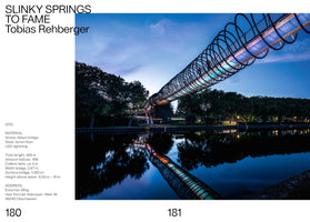 A two-page book spread featuring the Slinky Springs to Fame bridge by Tobias Rehberger. The right page is a photo of the bridge at twilight, stretching over a calm river. Shaped like a giant Slinky, its black spiral structure is internally lit with blue and orange lights, creating a stunning reflection in the water. The left page contains text with details about the artwork.