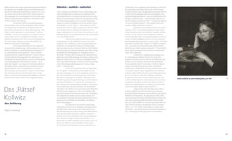 A two-page spread from a book in German. The pages feature columns of text about the artist Käthe Kollwitz. On the right is a black-and-white photograph of Kollwitz from 1909, sitting at a table and resting her head on her hand in a pensive pose, with an etching plate in front of her.