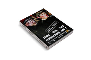 A book titled Sieh Dir Die Menschen An! is shown at an angle on a white surface. The black cover features a painting in the New Objectivity style of two men in caps looking upwards. The title is printed in large, white, sans-serif font, with English and German subtitles describing the book's focus on type portraits in the Weimar period.