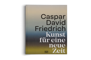 A hardcover book titled Caspar David Friedrich Kunst für eine neue Zeit, from publisher Hatje Cantz. The cover features a vertical color gradient background that shifts from a pale beige at the top, through a dusky blue in the middle, to a muted olive green at the bottom. The title is set in large black and white letters. The book is placed on a white surface, casting a soft shadow.