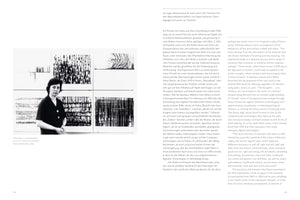 A two-page book spread showing a black-and-white photograph of artist Sofie Dawo in 1964. She stands in front of a grid of her six abstract ink drawings, which feature dense, varied line patterns on white paper. The photograph is on the left page, surrounded by text in German, while the right page features a column of English text.