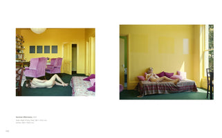 A photographic diptych set in a room with bright yellow walls and green carpet. The left photo shows a nude person with dark hair lying face down on the floor near two plush magenta armchairs. The right photo shows a nude blonde person reclining on a daybed with pink pillows, bathed in sunlight from a large window.