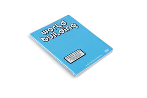 The exhibition catalog for world building, a book with a light blue cover, is shown at an angle against a white background. The title is written in a white, blocky, pixelated font. A white sticker below the title reads Videospiele und kunst im digitalen zeitalter. The names Julia Stoschek Foundation and Hatje Cantz are also visible.