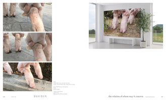 A two-page spread from an art book. The left page features three close-up photographs of a person wearing white gloves manipulating a pig's leg and foot on a paved surface. The right page shows a photograph of a modern, minimalist gallery where a large artwork depicting pig's feet standing in dirt is displayed on a wall above a white bench.