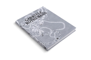 An angled, high-key shot of a grey hardcover book on a white background. The cover features the title GABRIELE ROTHEMANN in black text over a detailed, light-grey illustration of several intertwined snakes.