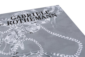 An angled close-up of a grey book cover for Gabriele Rothemann. The cover features a detailed, monochrome illustration of multiple snakes with different patterns intertwined. The artist's name is printed in a black serif font across the top portion of the image.