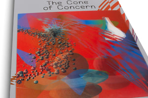 A close-up, angled photograph of a publication titled The Cone of Concern. The cover features a vibrant abstract digital artwork with a red and orange background, showing a cluster of small, asteroid-like spheres and a spiky structure amidst translucent blue and red geometric shapes.