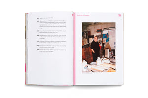An open book displays a two-page spread. The left page, numbered 18, shows a timeline of biographical information. The right page, numbered 19 and titled Boris Lurie - A Biography, features a color photograph of the artist Boris Lurie standing in his cluttered studio, circa 1990.