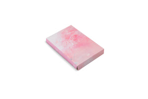 An angled view of a rectangular book with an abstract, painterly cover in shades of pink and white, lying on a white background. The title, ZHOU LI, is visible in a light-colored font on the cover.