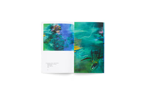 A top-down photograph of an open art book on a white background. The book displays a two-page spread of a large abstract painting in vibrant shades of blue, teal, and green, overlaid with energetic black, yellow, and pink brushstrokes. The left page features text below the artwork with its title and details.