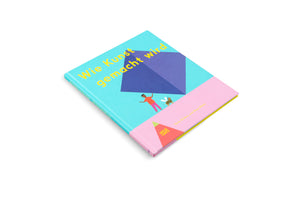 A hardcover children's book titled Wie Kunst gemacht wird is shown at an angle on a white background. The colorful cover is split between a turquoise top and a pink bottom, featuring yellow text, a large blue geometric shape, and illustrations of a person and a bee.