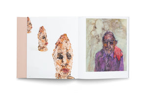 An open art book is displayed on a white surface, showing a two-page spread. The left page features three heavily textured, sculpted busts with distorted faces against a white background. The right page displays an expressive painting of a person in a purple shirt with a somber face, and a large, bright red hand resting on their shoulder.