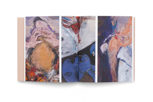 A high-angle studio shot of an open art book with a tan cover, displaying a triptych of colorful, expressionist paintings. The abstract artwork features fragmented figures and faces rendered in bold brushstrokes of purple, blue, orange, and red against a plain white background.