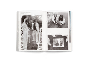 An open book with a two-page spread of black-and-white photographs. The photos show John Lennon and Yoko Ono, both dressed in white, on a lawn. They are depicted digging a hole with a shovel and kneeling to plant something. One close-up shows a reflective plaque on the grass commemorating the event in May 1968.