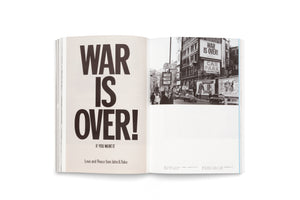 An open book displays John and Yoko's WAR IS OVER! peace campaign. The left page shows the poster with its iconic bold, black text. The right page features a black-and-white photograph of the poster on a billboard overlooking a busy city street in the 1960s.
