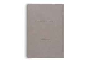 A book with a textured, solid grey cover stands vertically against a white background. Small black text is printed on the cover. The top line reads FF-CO-01–FF-CO-71 FFE-IT-15-B–FFE-BE-24-S 2013–2024. The bottom line reads FREQUENCIES Oscar Murillo.