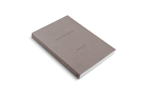 An angled, high-view shot of a thick, minimalist hardcover book with a solid grey-brown cover, set against a plain white background. The front cover features the title FREQUENCIES and the author Oscar Murillo in small black text. The spine also has text, including the years 2013-2024.