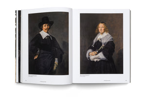 An open art book lying flat on a white surface. The two-page spread displays 17th-century portraits. On the left is a painting of a man with a mustache, wearing a black hat and a white collar. On the right is a painting of a woman in a dark dress with a large, sheer white collar, holding a fan.