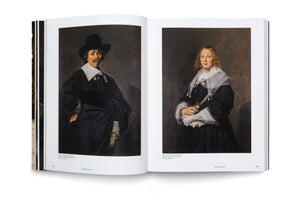 An open art history book lies on a white surface, displaying two pages with portraits by Frans Hals. The left page shows a man with a mustache in a black hat and clothing with a white collar. The right page shows a woman in a black dress with an elaborate white lace collar, holding a fan.