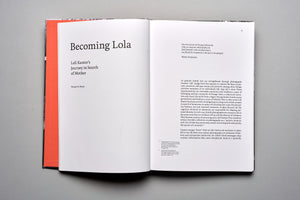 A high-angle photo of an open book lying on a flat grey surface. The left page is a title page reading, Becoming Lola, Loli Kantor's Journey in Search of Mother by Nissan N. Perez. The right page contains paragraphs of text, starting with a quote from Walter Benjamin.