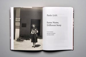 An open book laid flat on a gray surface. The left page displays a vintage black-and-white photograph of a woman in a striped shirt and dark skirt standing outdoors. The right page serves as a title page, reading, Paris 12:05. Same Name, Different Story. A conversation between Loli Kantor and Danna Heller.