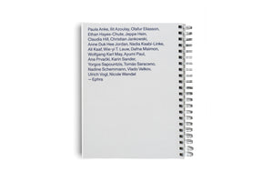 A white page of a spiral-bound notebook seen against a white background. The page features a list of names printed in a dark blue sans-serif font, starting with Paula Anke, Ilit Azoulay, Olafur Eliasson, and ending with — Ephra. The silver spiral binding is visible along the right edge.